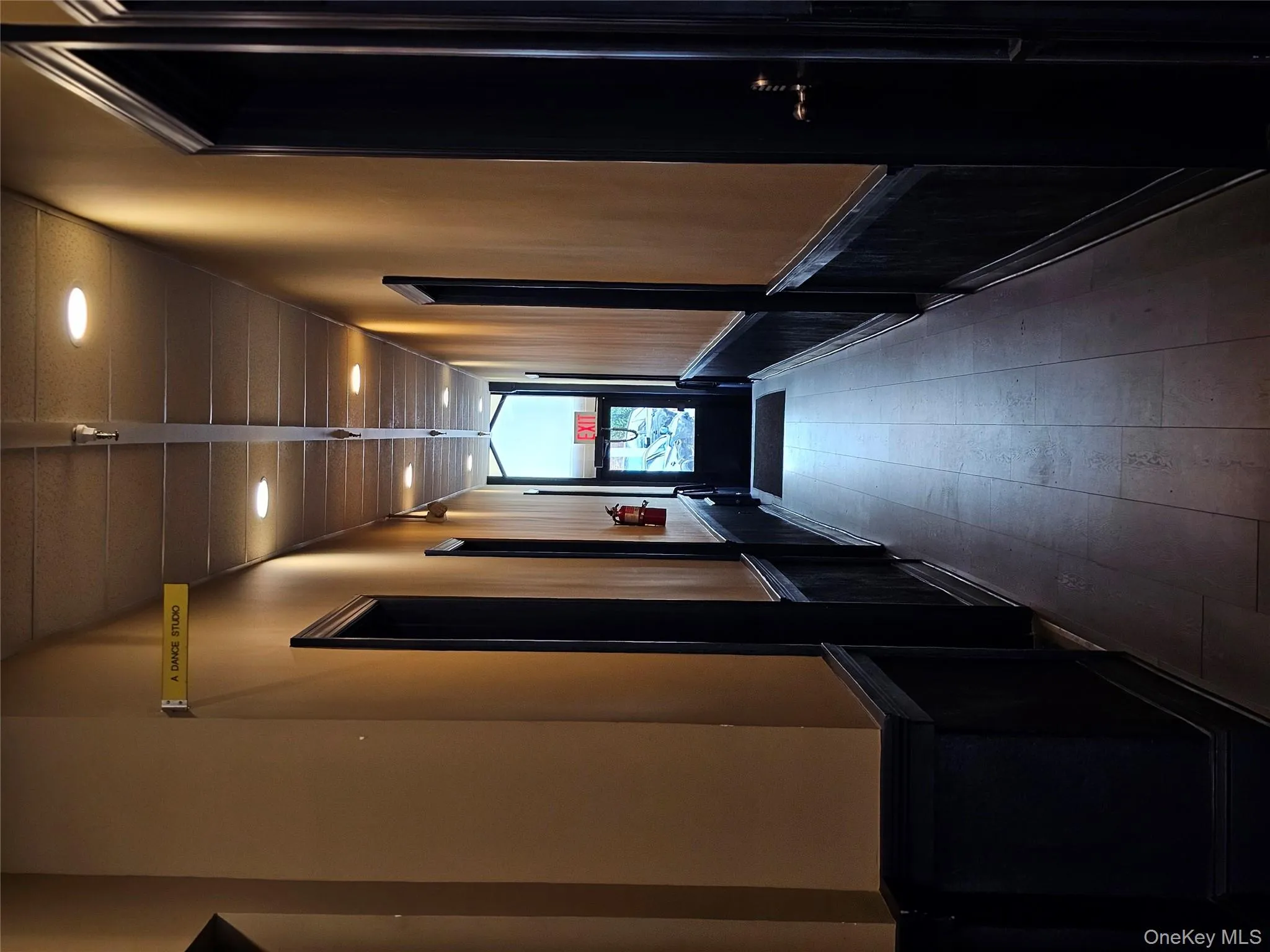 Hallway with wainscoting, elevator, and recessed lighting Hallway with wainscoting, elevator, and recessed lighting