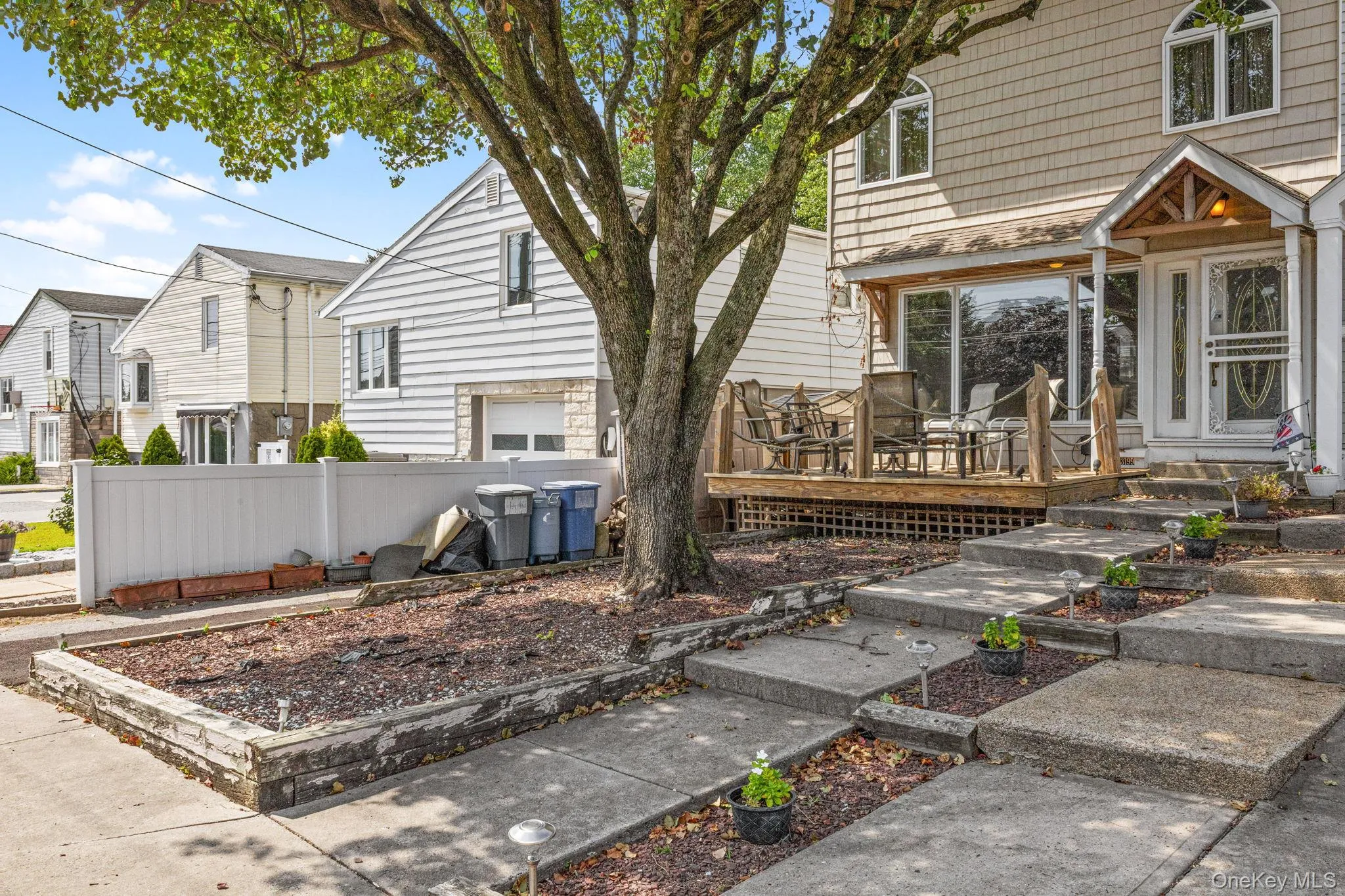 View of front facade with a deck and a residential view View of front facade with a deck and a residential view