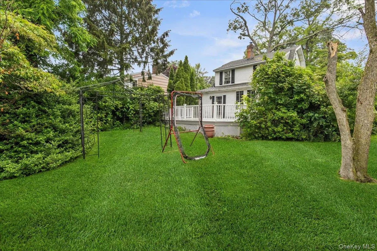 View of grassy yard with a deck View of grassy yard with a deck