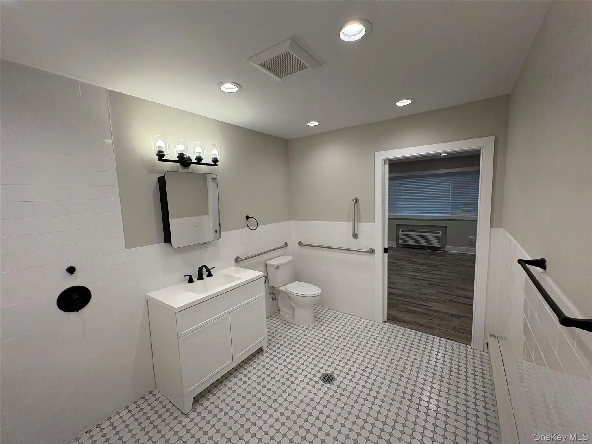 Full bath with wainscoting, vanity, and recessed lighting Full bath with wainscoting, vanity, and recessed lighting