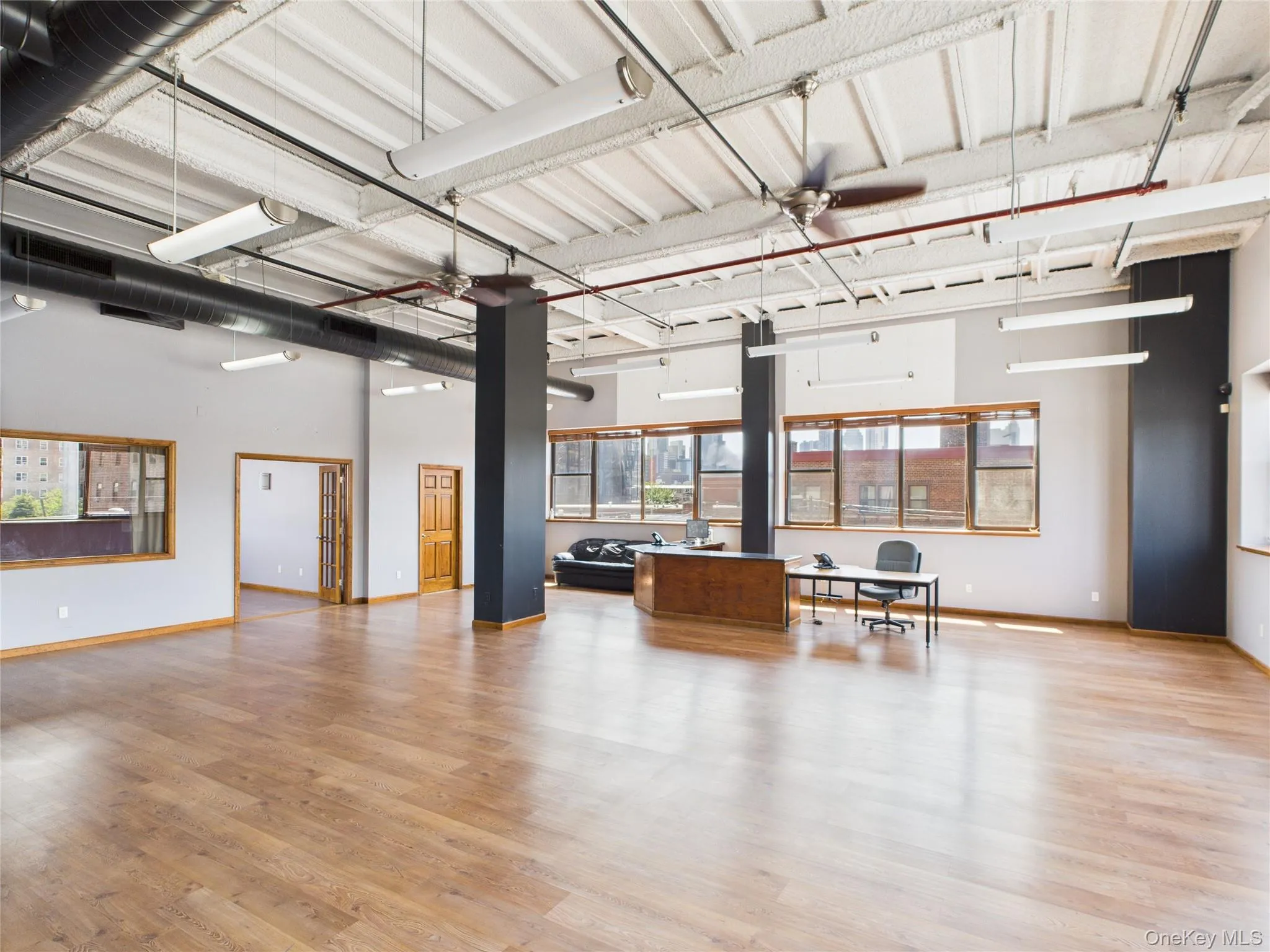 Garage featuring a ceiling fan and baseboards Garage featuring a ceiling fan and baseboards