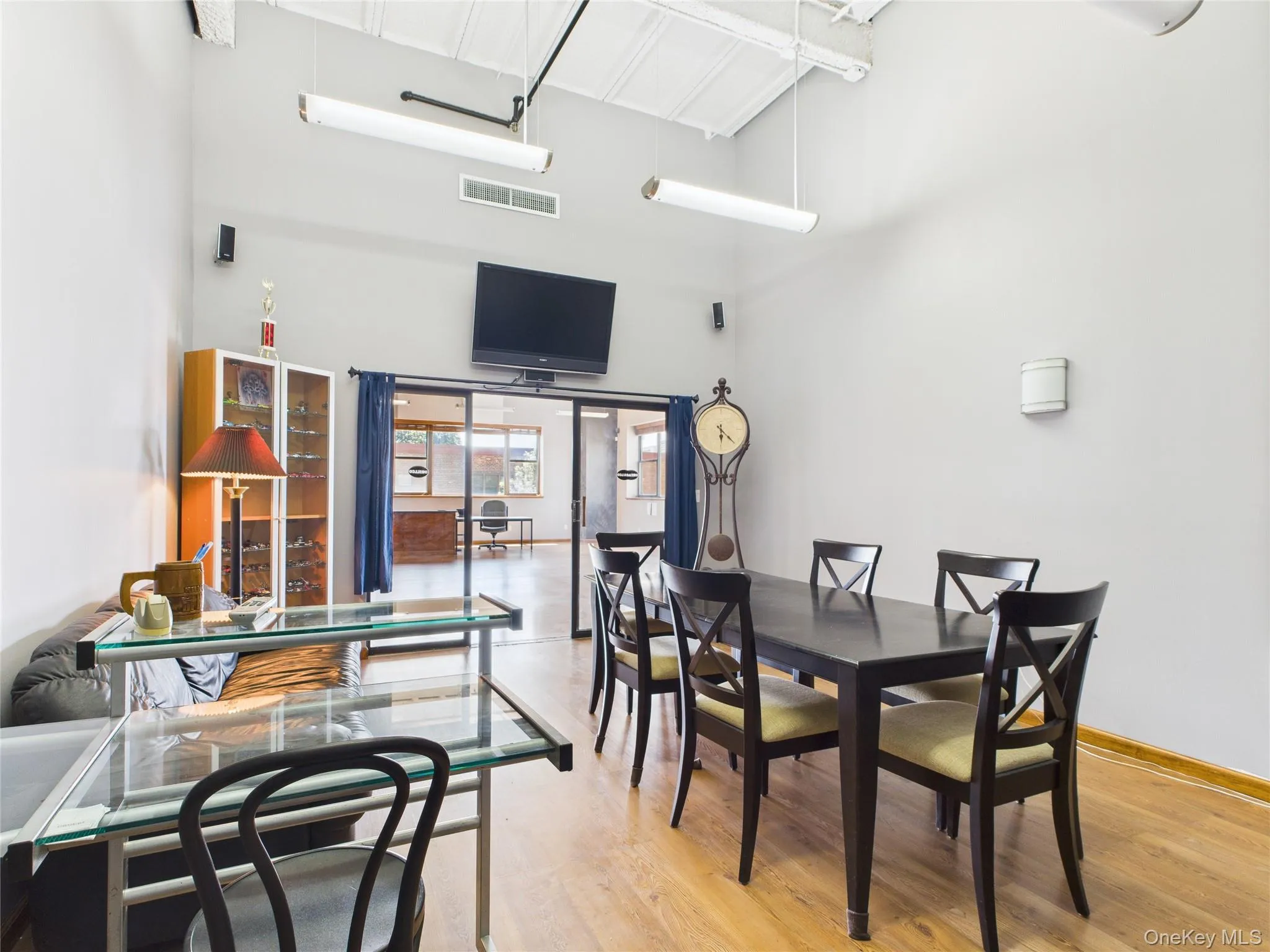 Dining room with wood finished floors and a towering ceiling Dining room with wood finished floors and a towering ceiling