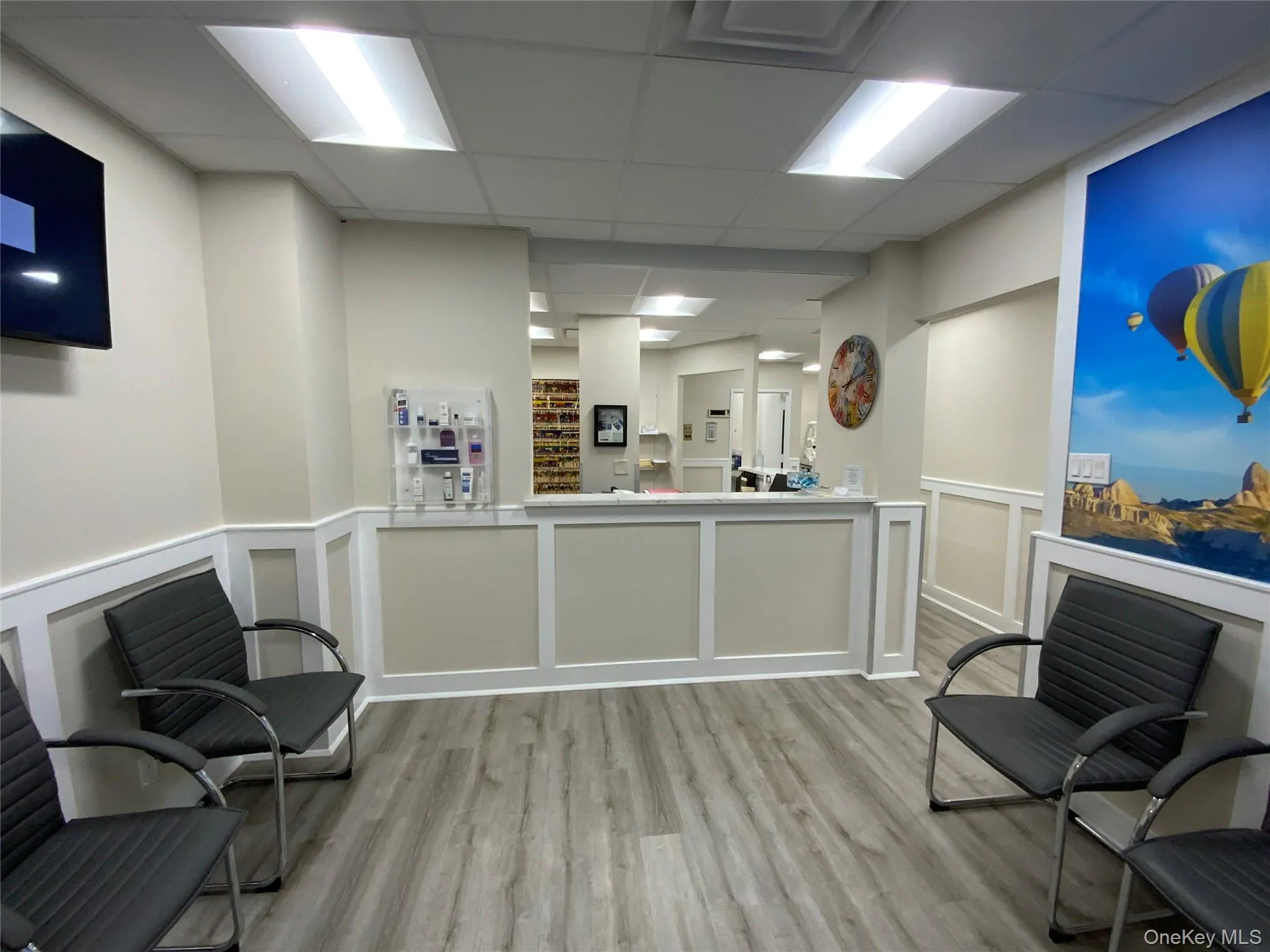 Reception with a paneled ceiling, a decorative wall, and a wainscoted wall Reception with a paneled ceiling, a decorative wall, and a wainscoted wall