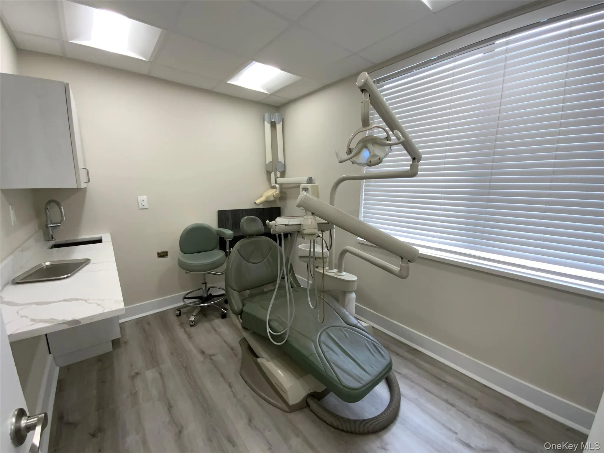 Misc room with light wood-style flooring and a drop ceiling Misc room with light wood-style flooring and a drop ceiling