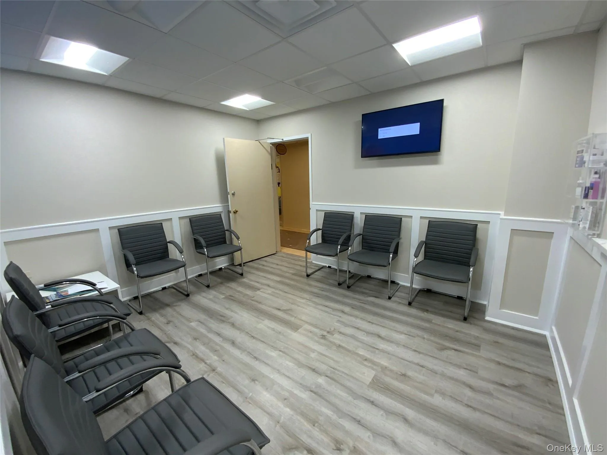 Office space featuring a drop ceiling and light wood finished floors Office space featuring a drop ceiling and light wood finished floors