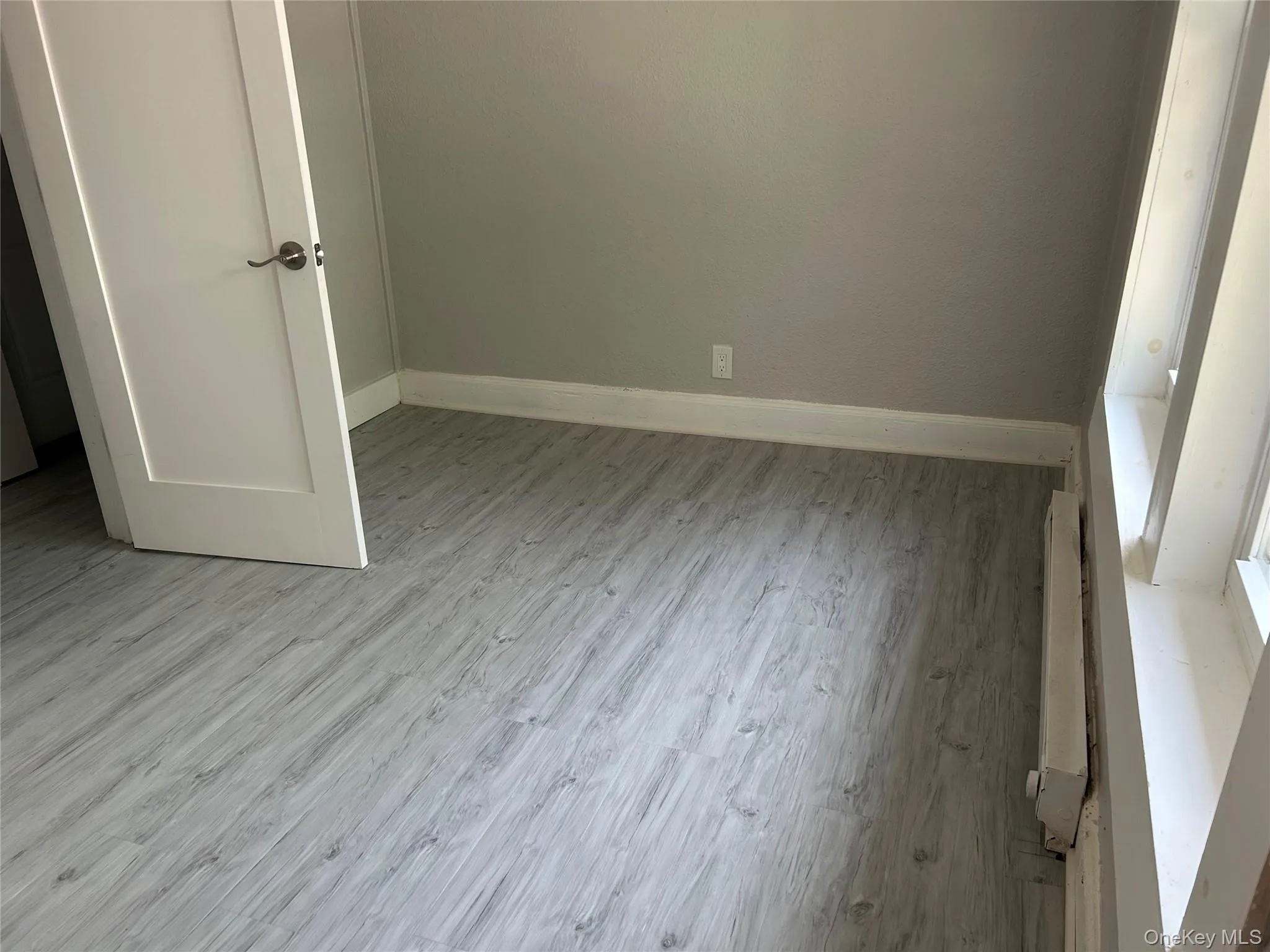 Unfurnished bedroom with baseboards and light wood-style floors Unfurnished bedroom with baseboards and light wood-style floors