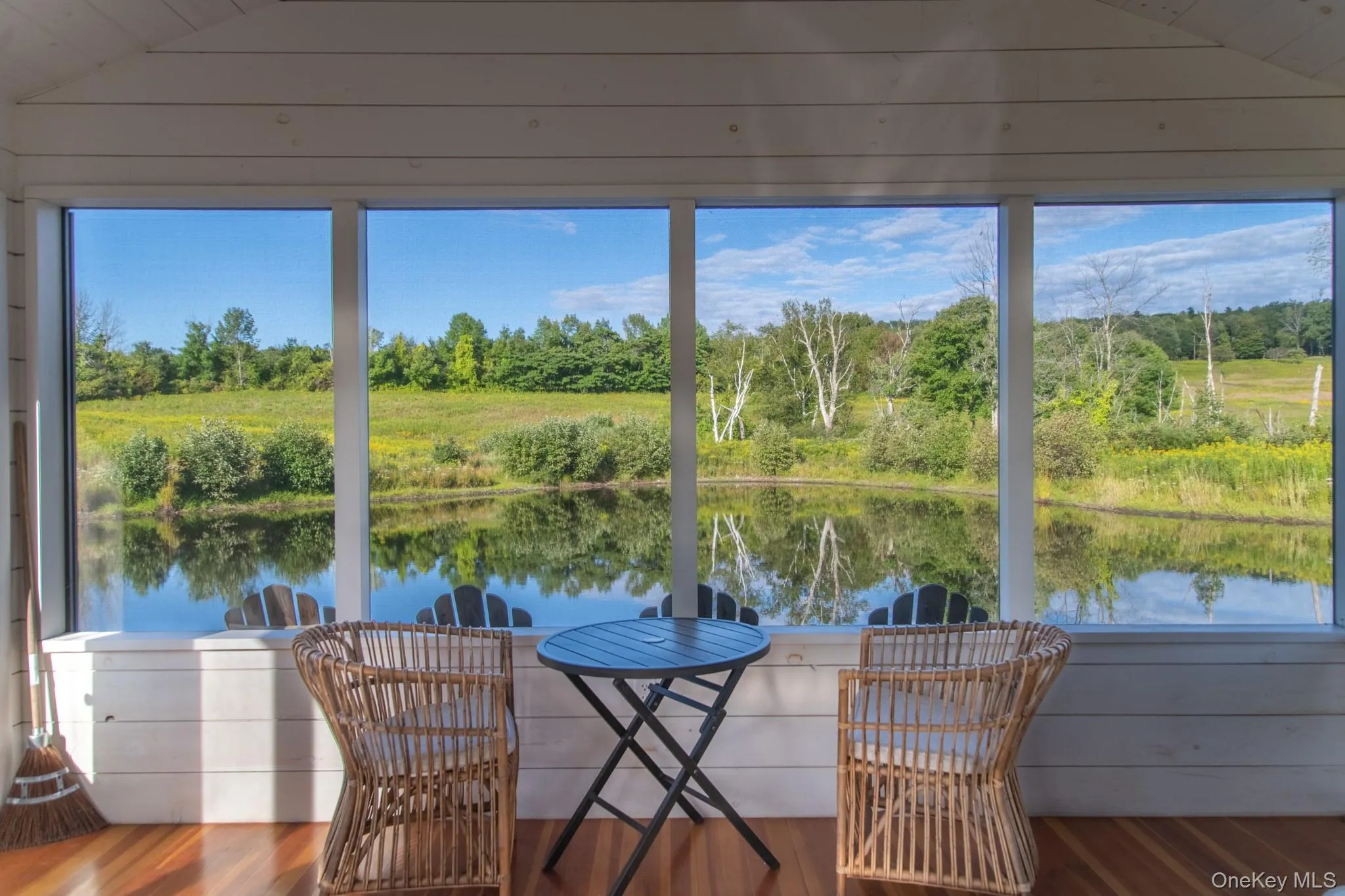 Interior of screened pond porch, with view Interior of screened pond porch, with view