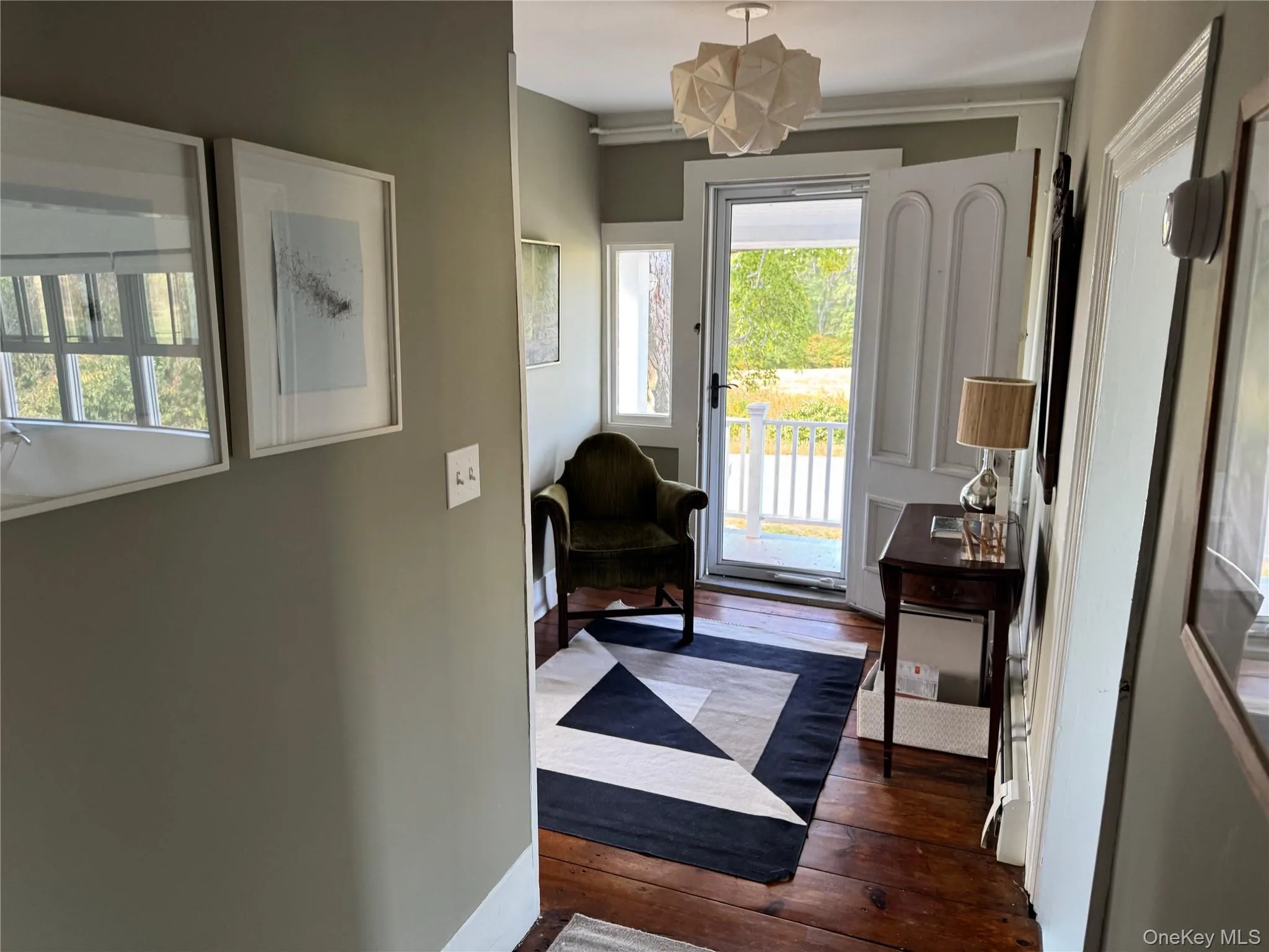 Entryway featuring wood-type flooring and baseboards Entryway featuring wood-type flooring and baseboards
