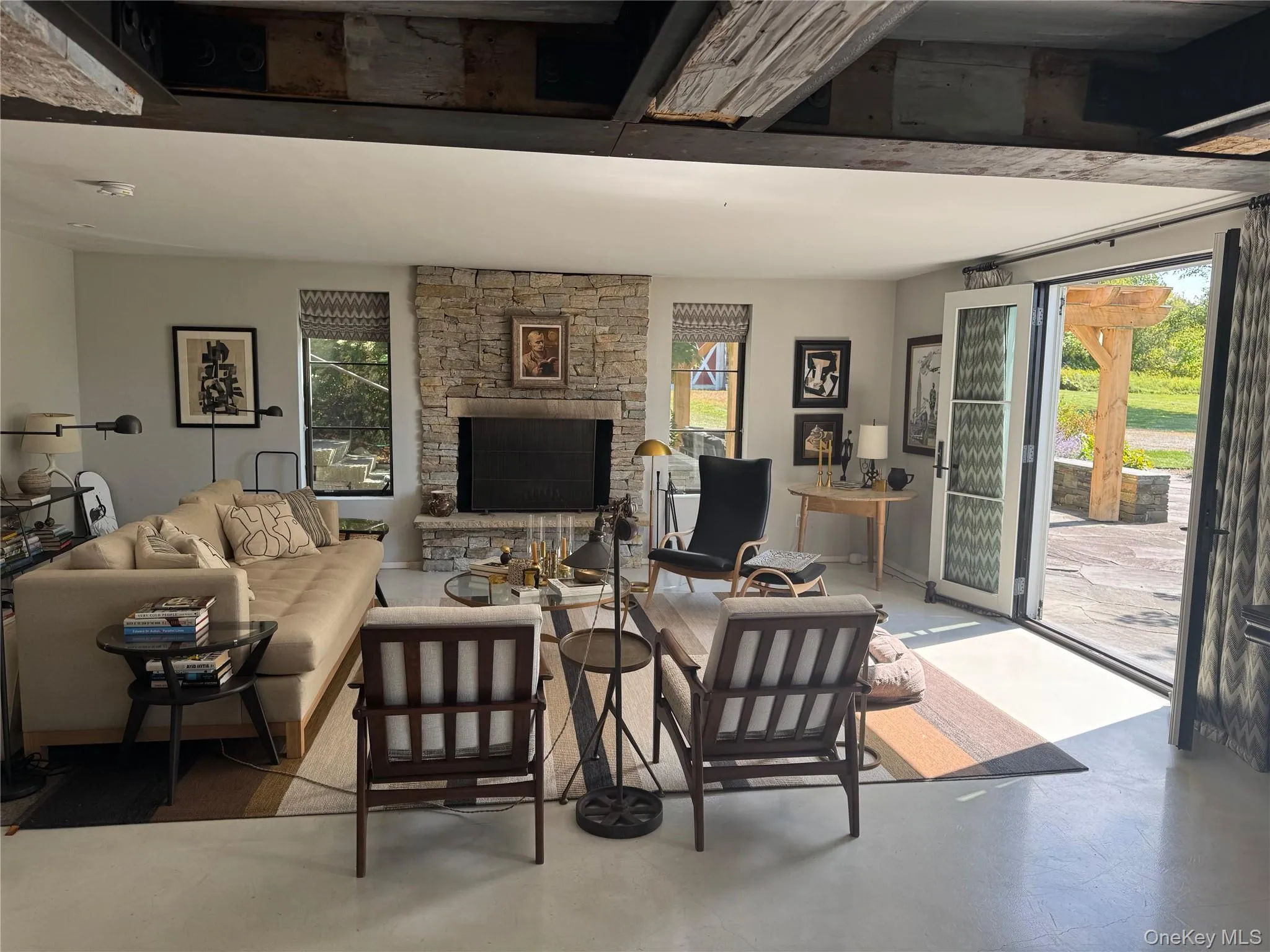 Living area featuring a fireplace and concrete floors Living area featuring a fireplace and concrete floors