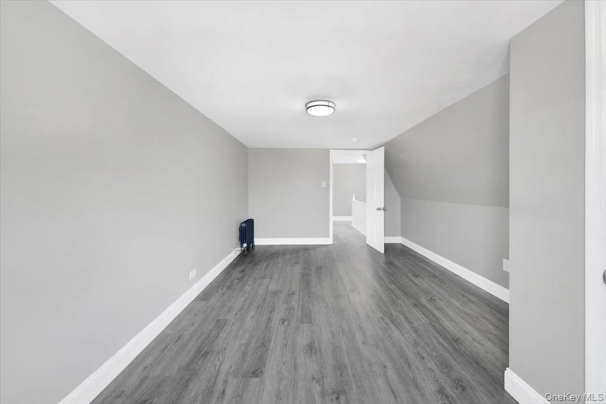 Bonus room featuring wood finished floors and lofted ceiling Bonus room featuring wood finished floors and lofted ceiling
