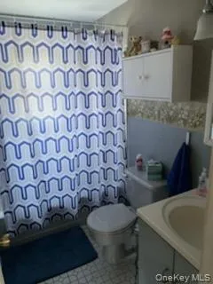 Full bath featuring vanity and shower / bath combination with curtain Full bath featuring vanity and shower / bath combination with curtain