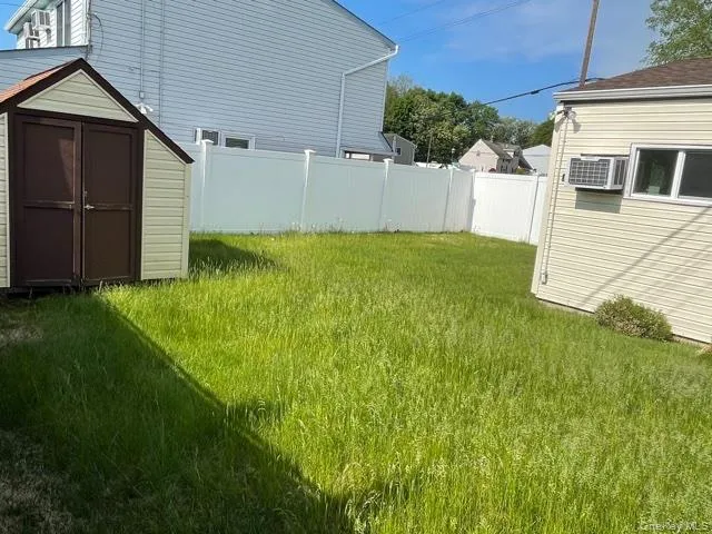 View of yard featuring a storage unit View of yard featuring a storage unit
