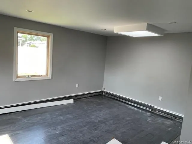 Unfurnished room featuring baseboard heating Unfurnished room featuring baseboard heating