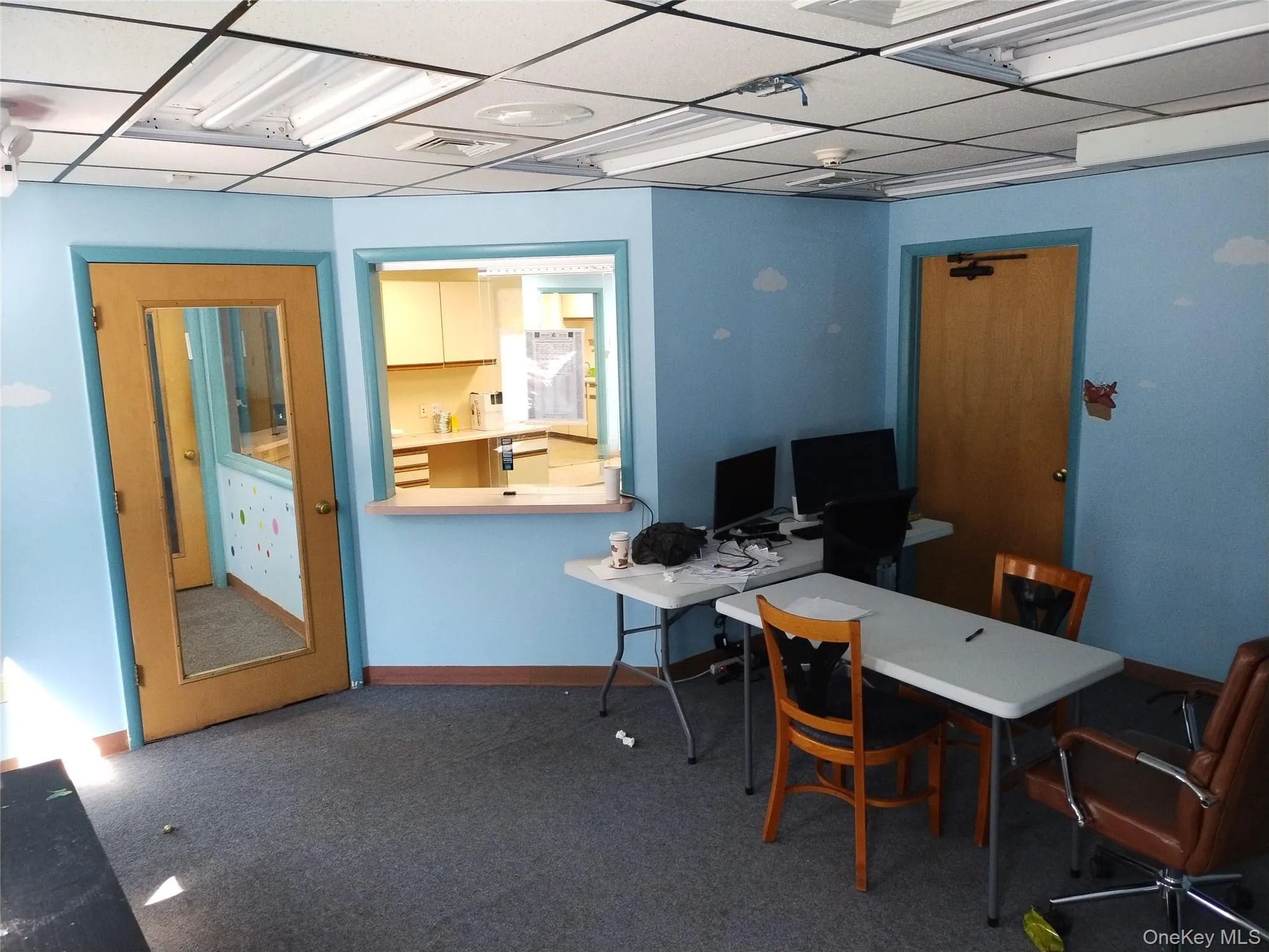 Carpeted office with a drop ceiling and baseboards Carpeted office with a drop ceiling and baseboards