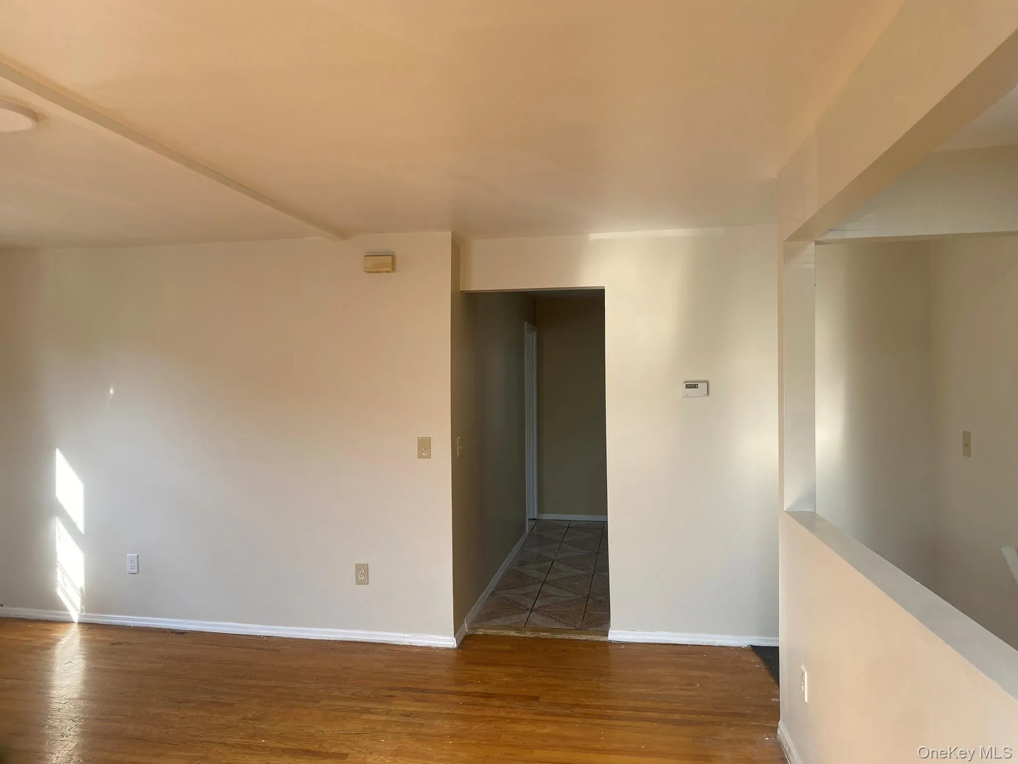 Empty room featuring wood finished floors and baseboards Empty room featuring wood finished floors and baseboards