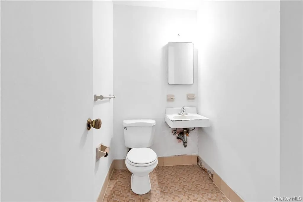 Bathroom with toilet and baseboards Bathroom with toilet and baseboards