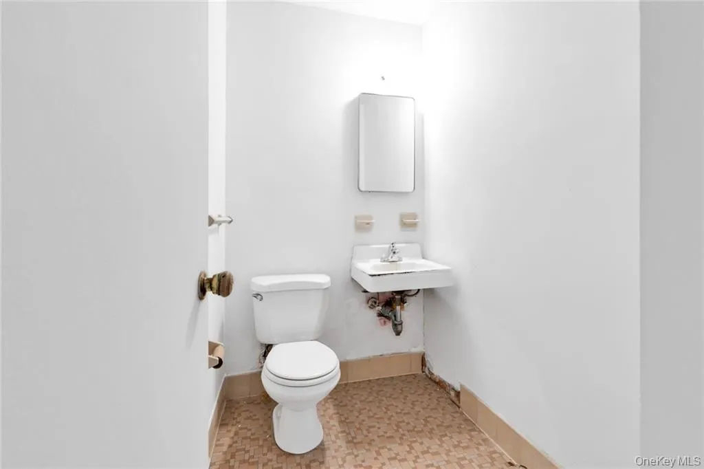 Half bath with toilet and baseboards Half bath with toilet and baseboards