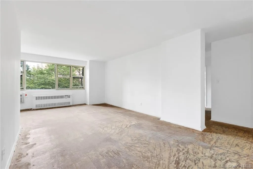 Spare room with radiator heating unit and baseboards Spare room with radiator heating unit and baseboards