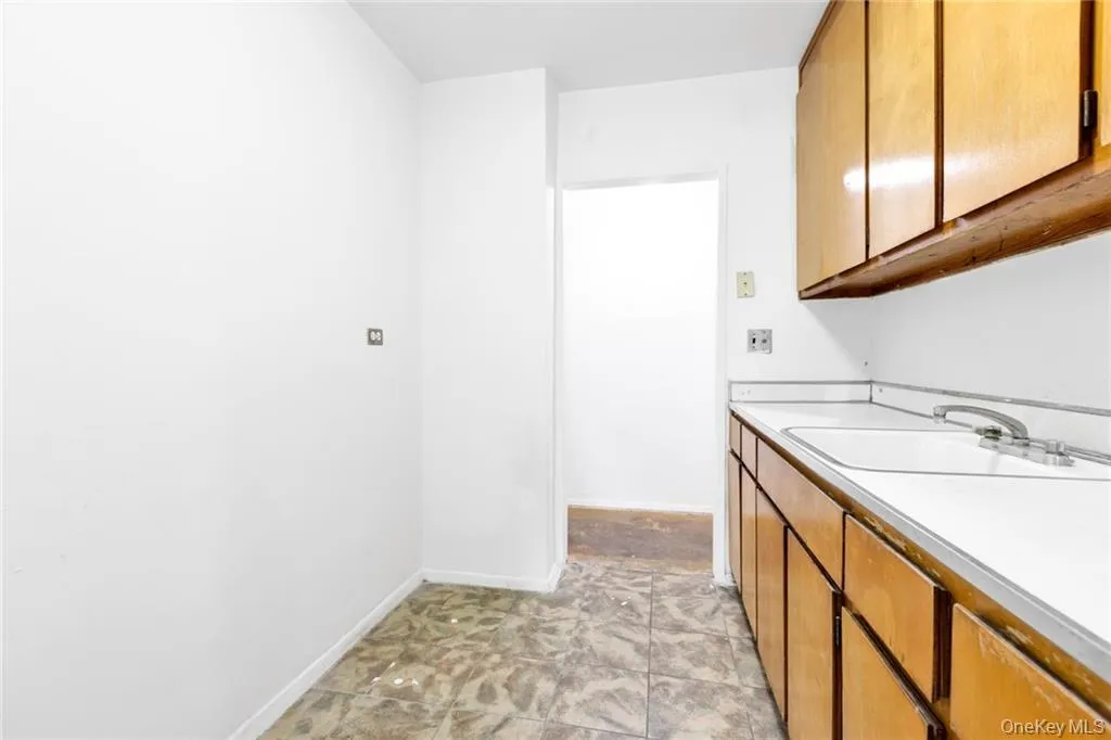 Bathroom featuring baseboards and vanity Bathroom featuring baseboards and vanity