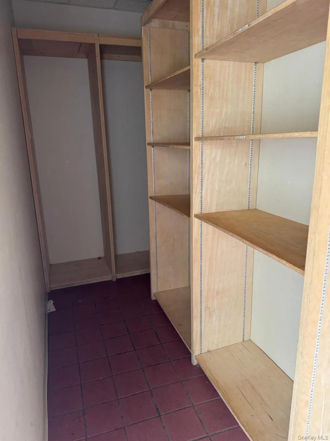 Corridor with dark tile patterned flooring Corridor with dark tile patterned flooring