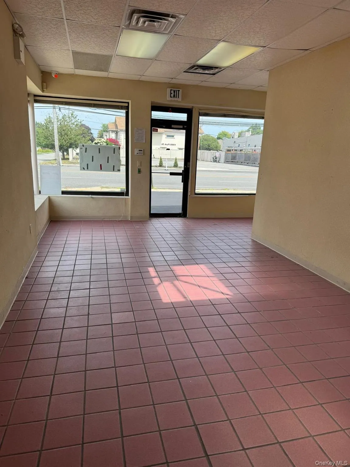 Spare room with a drop ceiling and tile patterned flooring Spare room with a drop ceiling and tile patterned flooring