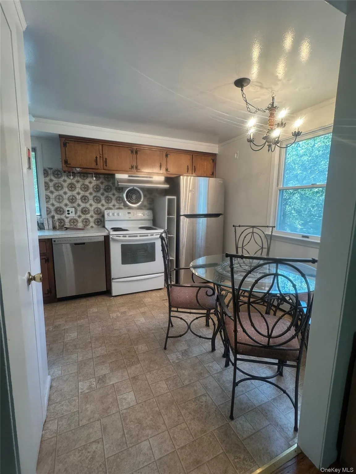 Kitchen featuring eat-in area & appliances backsplash, decorative light, countertops Kitchen featuring eat-in area & appliances backsplash, decorative light, countertops