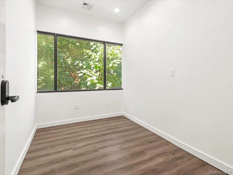 Spare room with dark wood finished floors and recessed lighting Spare room with dark wood finished floors and recessed lighting
