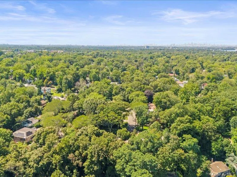 Aerial view of property\'s location with a heavily wooded area Aerial view of property\'s location with a heavily wooded area