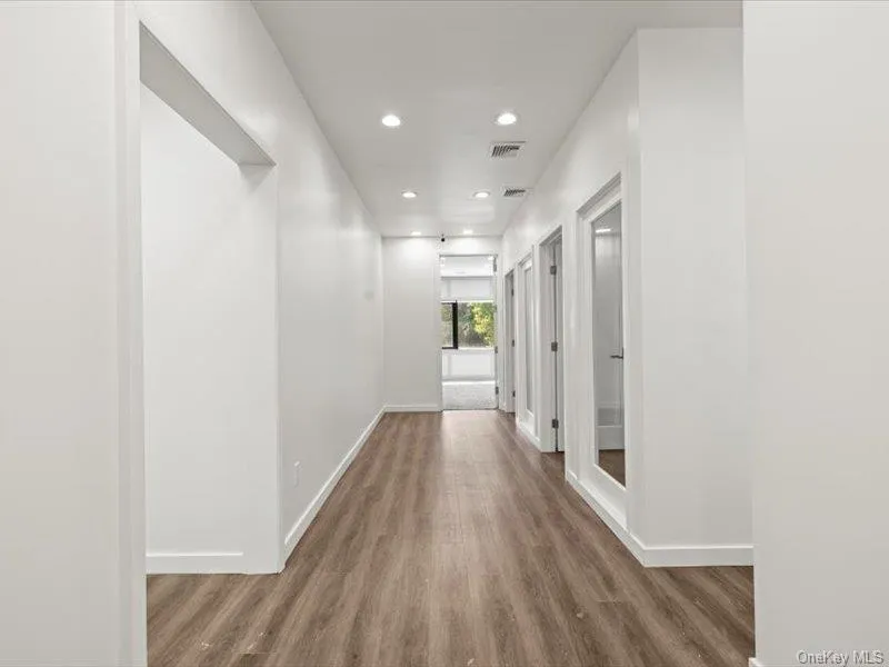 Corridor with recessed lighting and wood finished floors Corridor with recessed lighting and wood finished floors