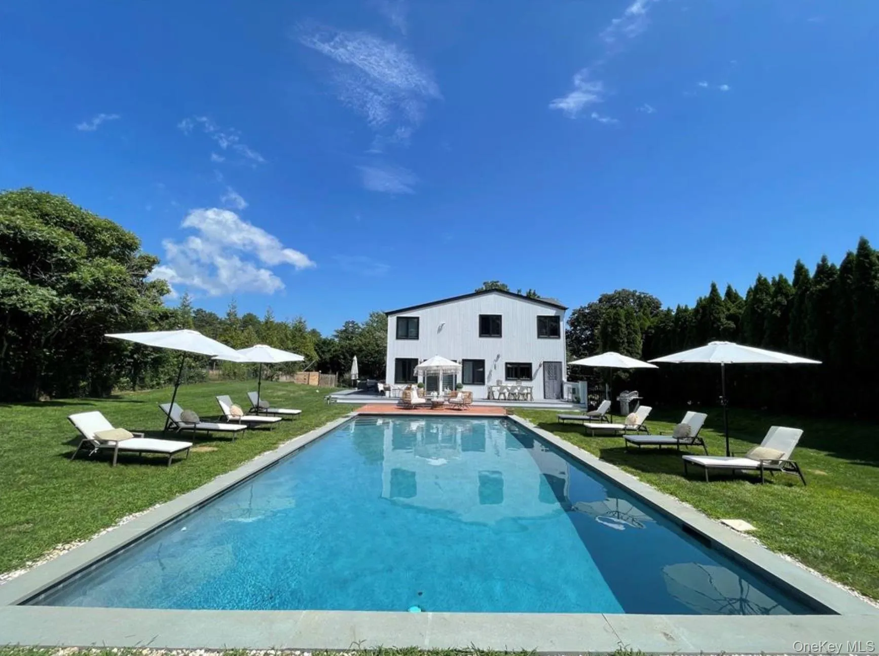 Outdoor pool with a lawn and a patio Outdoor pool with a lawn and a patio