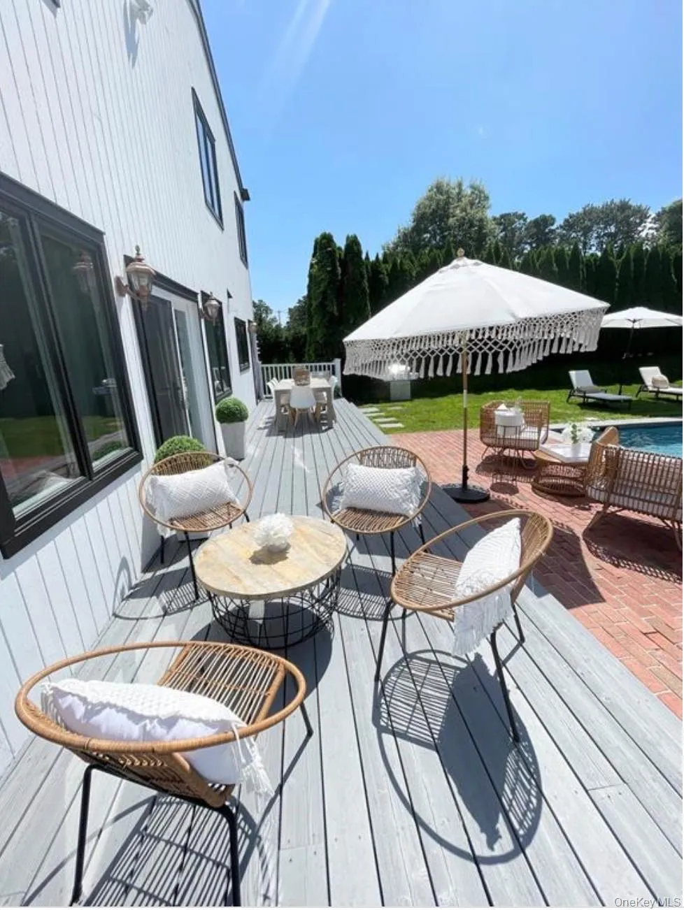 Wooden terrace with outdoor dining space and a patio Wooden terrace with outdoor dining space and a patio