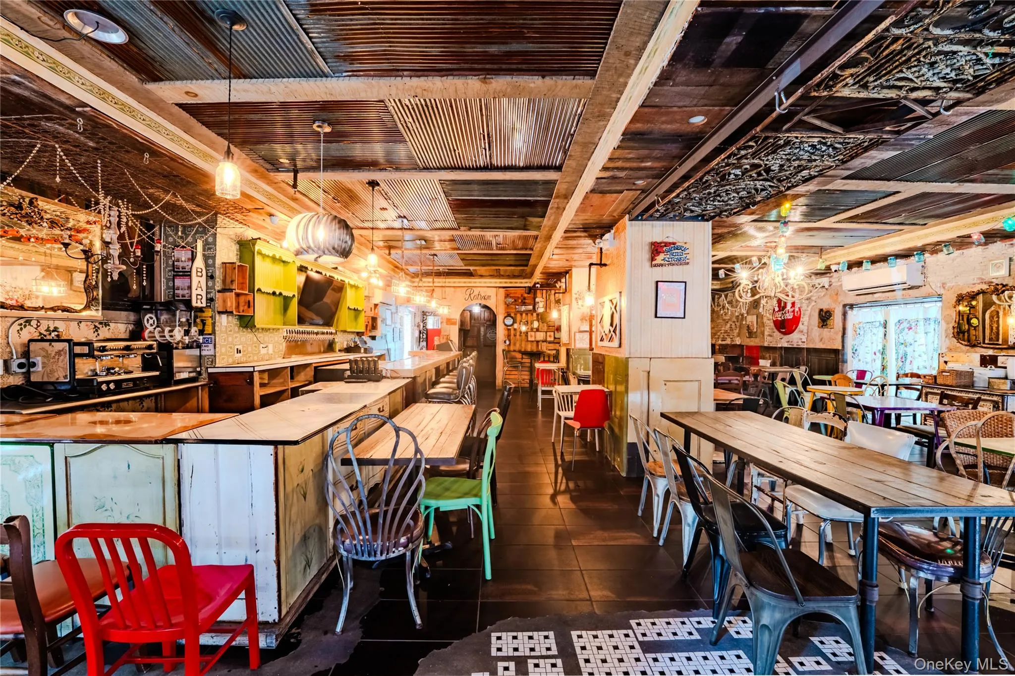 Dining area with wood walls, wood ceiling, dark tile patterned floors, and arched walkways Dining area with wood walls, wood ceiling, dark tile patterned floors, and arched walkways