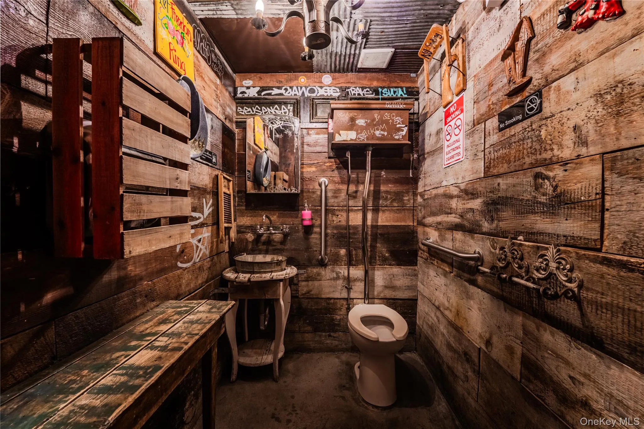 Bathroom featuring wooden walls and concrete floors Bathroom featuring wooden walls and concrete floors