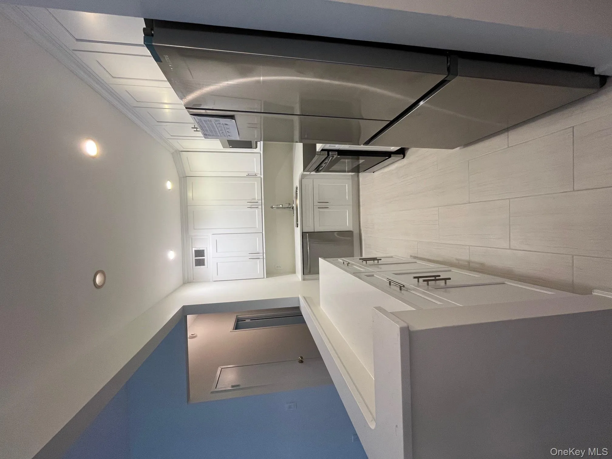 Kitchen featuring white cabinets, stainless steel fridge, recessed lighting, stove, and dishwashing machine Kitchen featuring white cabinets, stainless steel fridge, recessed lighting, stove, and dishwashing machine