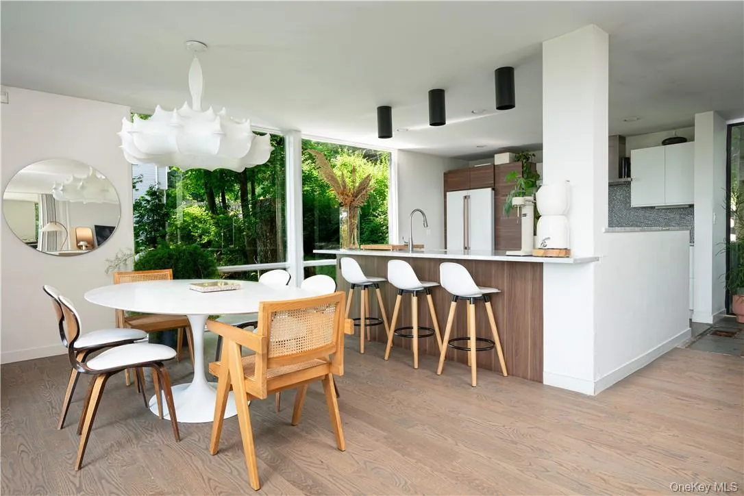 Dining space with sink and light hardwood / wood-style flooring Dining space with sink and light hardwood / wood-style flooring