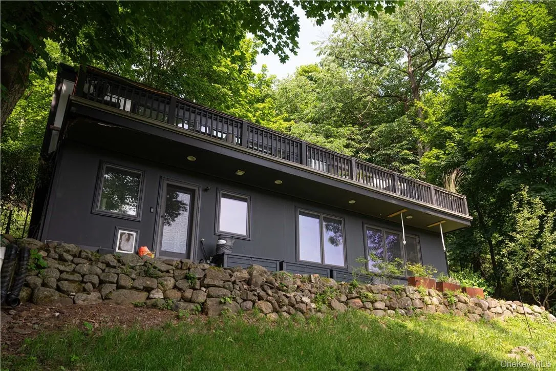 Rear view of house featuring a balcony Rear view of house featuring a balcony