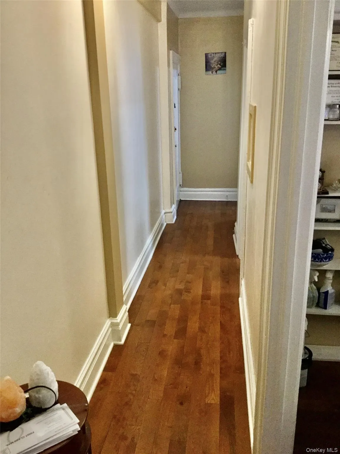 Hall with dark wood finished floors and baseboards Hall with dark wood finished floors and baseboards