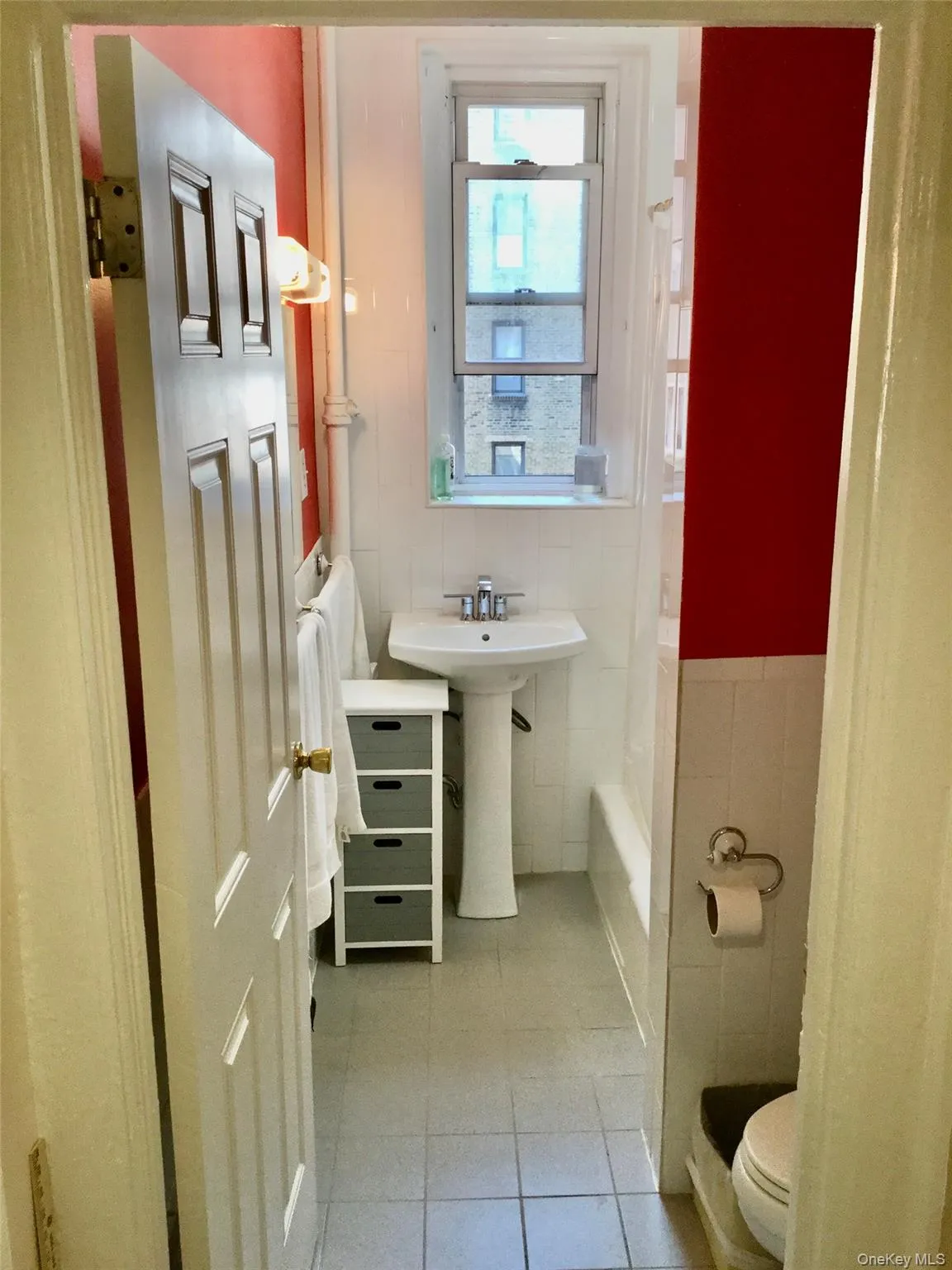 Full bathroom with tile walls and light tile patterned floors Full bathroom with tile walls and light tile patterned floors