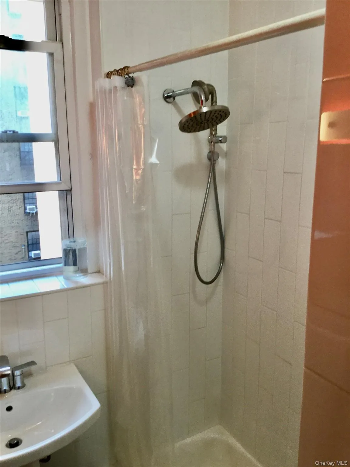 Full bath featuring a stall shower and a sink Full bath featuring a stall shower and a sink