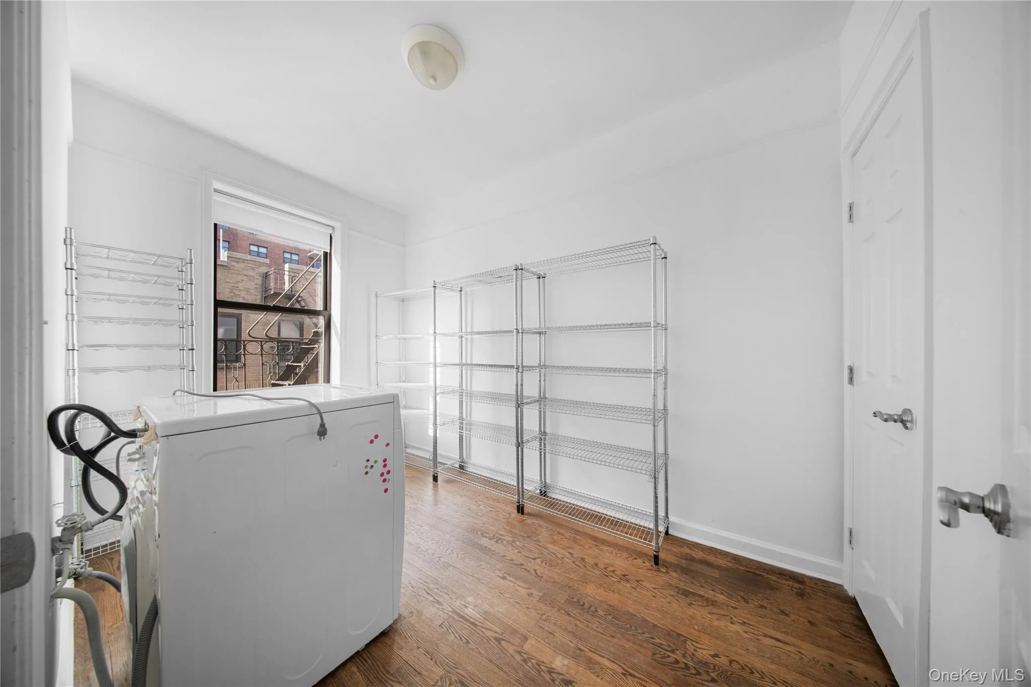 Office featuring dark wood-style flooring and washer / dryer Office featuring dark wood-style flooring and washer / dryer