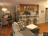 Living area featuring dark wood-style floors Living area featuring dark wood-style floors