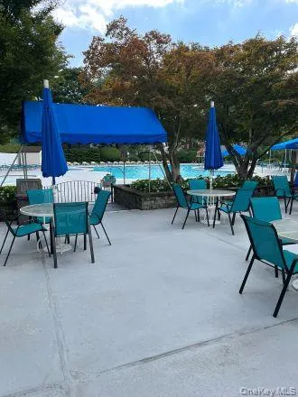 View of patio with outdoor dining space and a community pool View of patio with outdoor dining space and a community pool