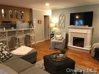 Living room with wood finished floors and a fireplace Living room with wood finished floors and a fireplace