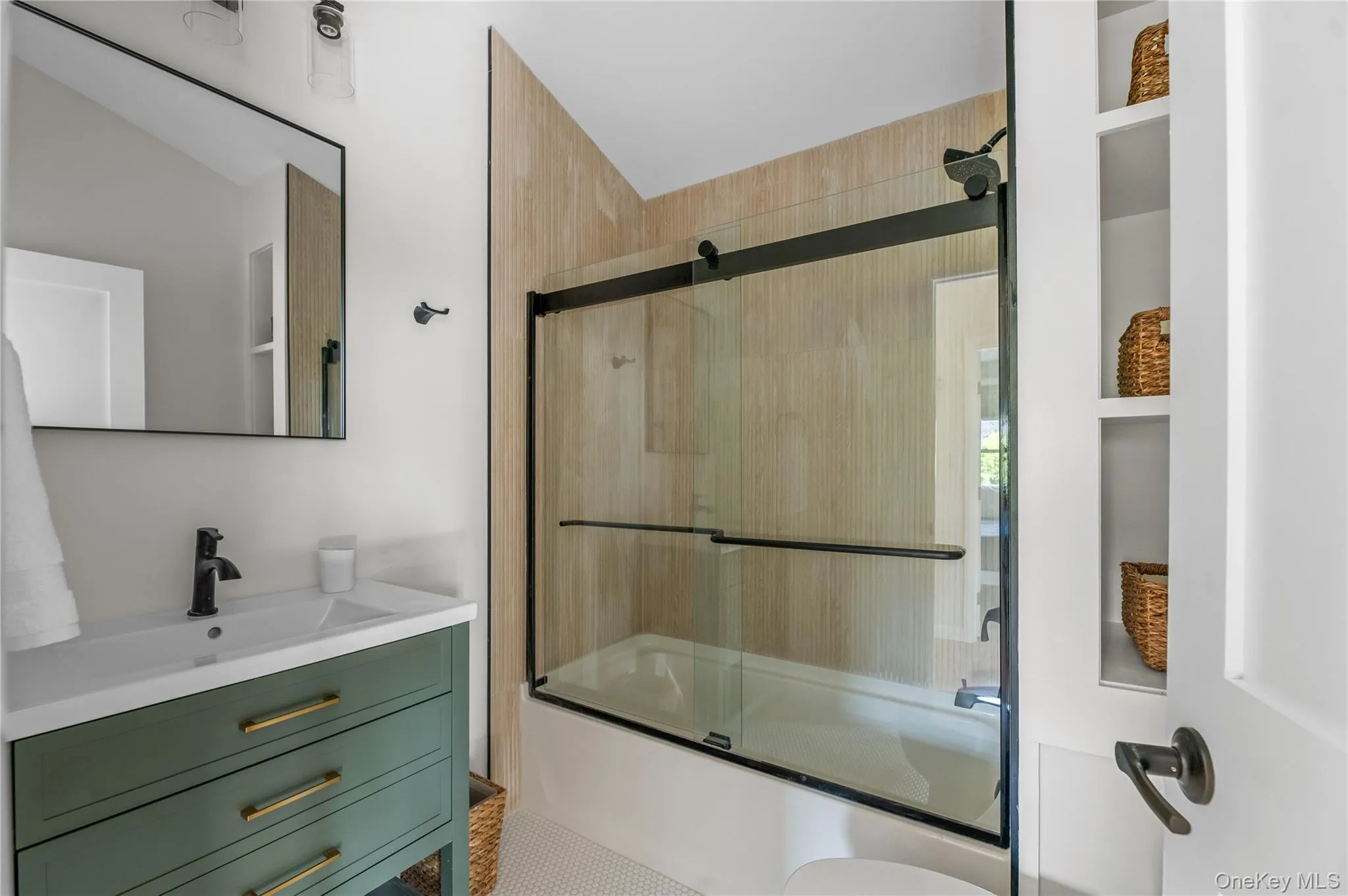 Bathroom featuring shower / bath combination with glass door and vanity Bathroom featuring shower / bath combination with glass door and vanity