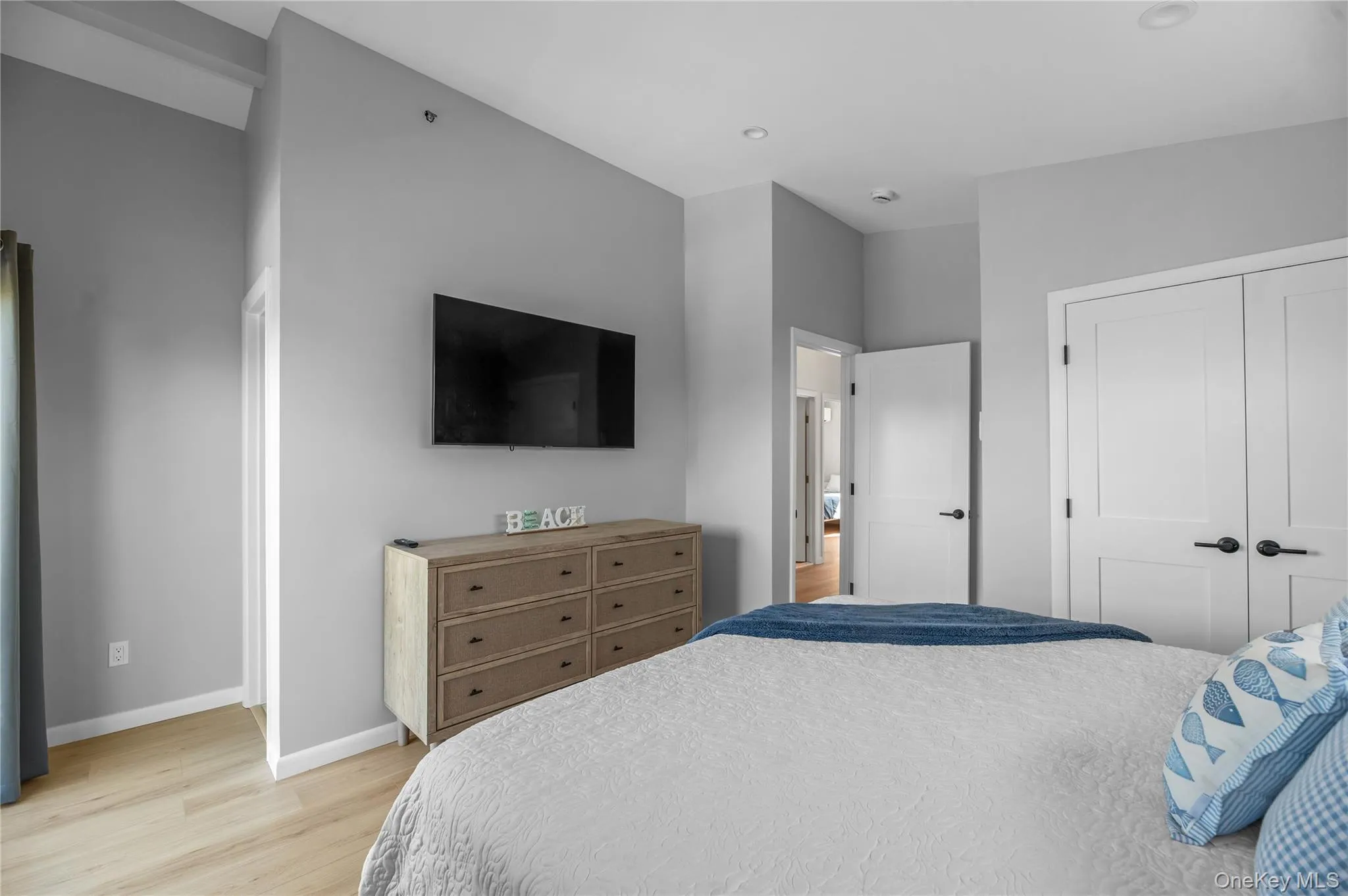 Bedroom with light wood-style floors and recessed lighting Bedroom with light wood-style floors and recessed lighting