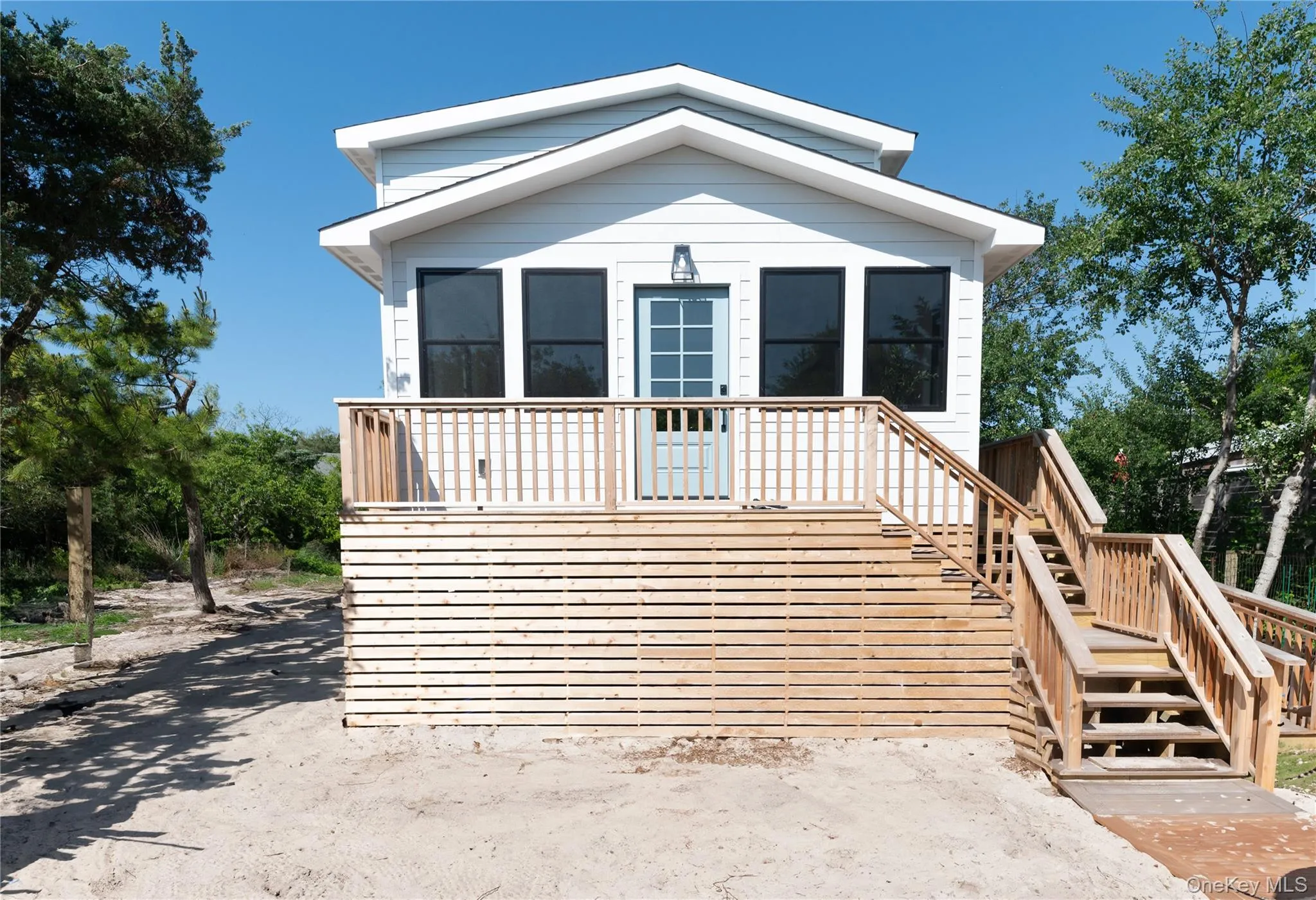 View of front of home featuring stairway and a wooden deck View of front of home featuring stairway and a wooden deck