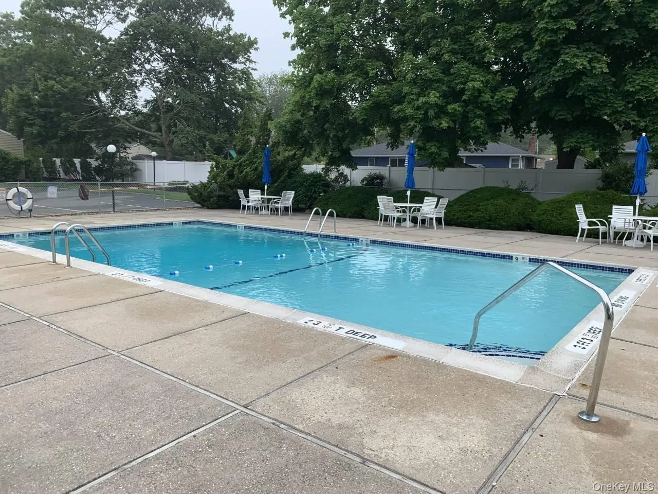Community pool with a patio area Community pool with a patio area