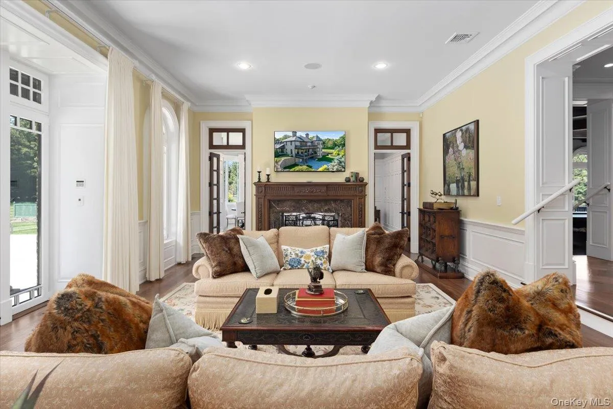 Living area with crown molding, wood finished floors, a wainscoted wall, a decorative wall, and recessed lighting Living area with crown molding, wood finished floors, a wainscoted wall, a decorative wall, and recessed lighting
