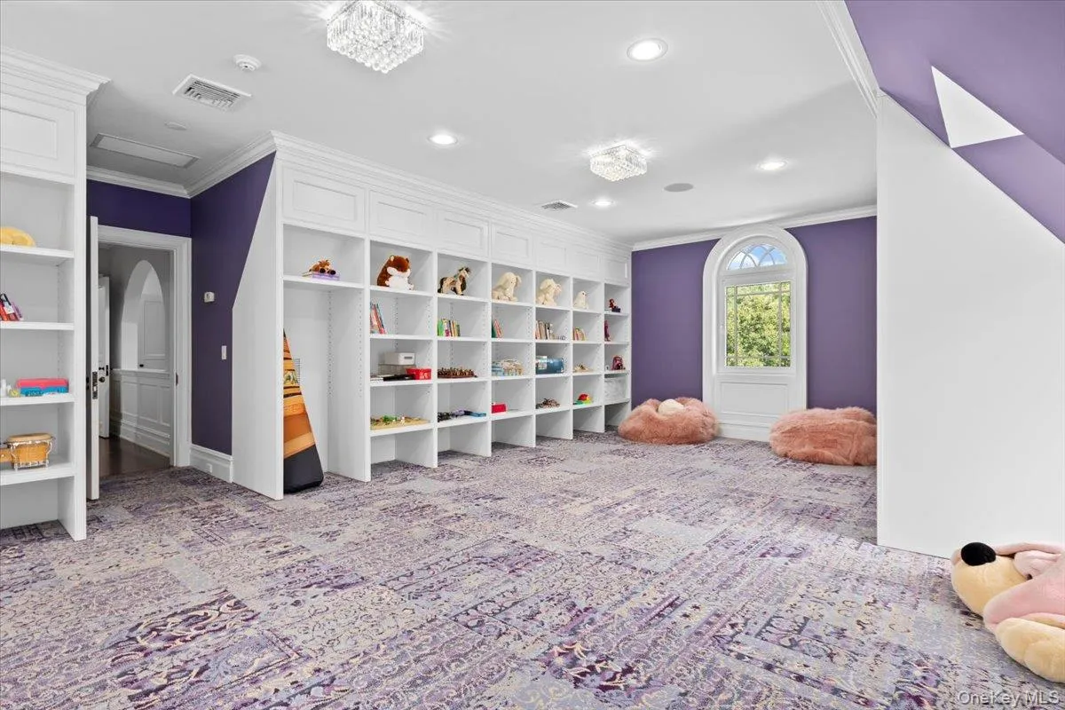Recreation room with crown molding, light colored carpet, and recessed lighting Recreation room with crown molding, light colored carpet, and recessed lighting