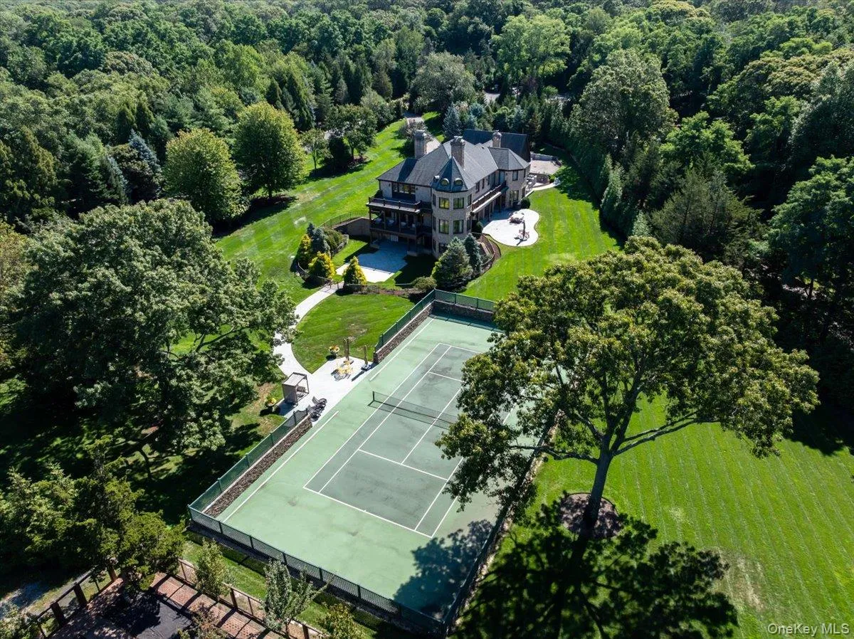 Aerial view of property and surrounding area featuring a heavily wooded area Aerial view of property and surrounding area featuring a heavily wooded area
